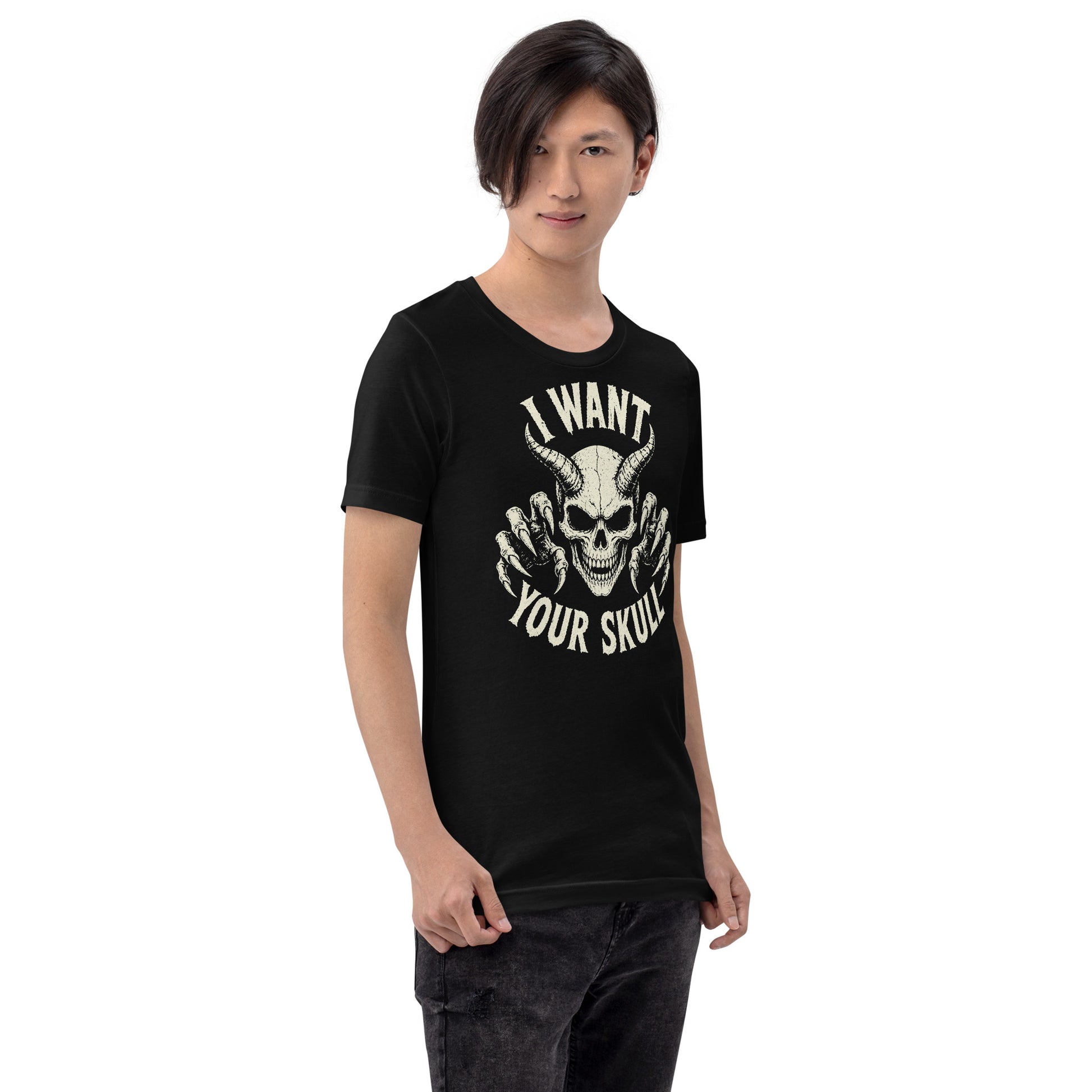 A retro-style graphic on a black t-shirt featuring a detailed horned demon skull with sharp claws and "I WANT YOUR SKULL" in distressed punk-rock lettering.
