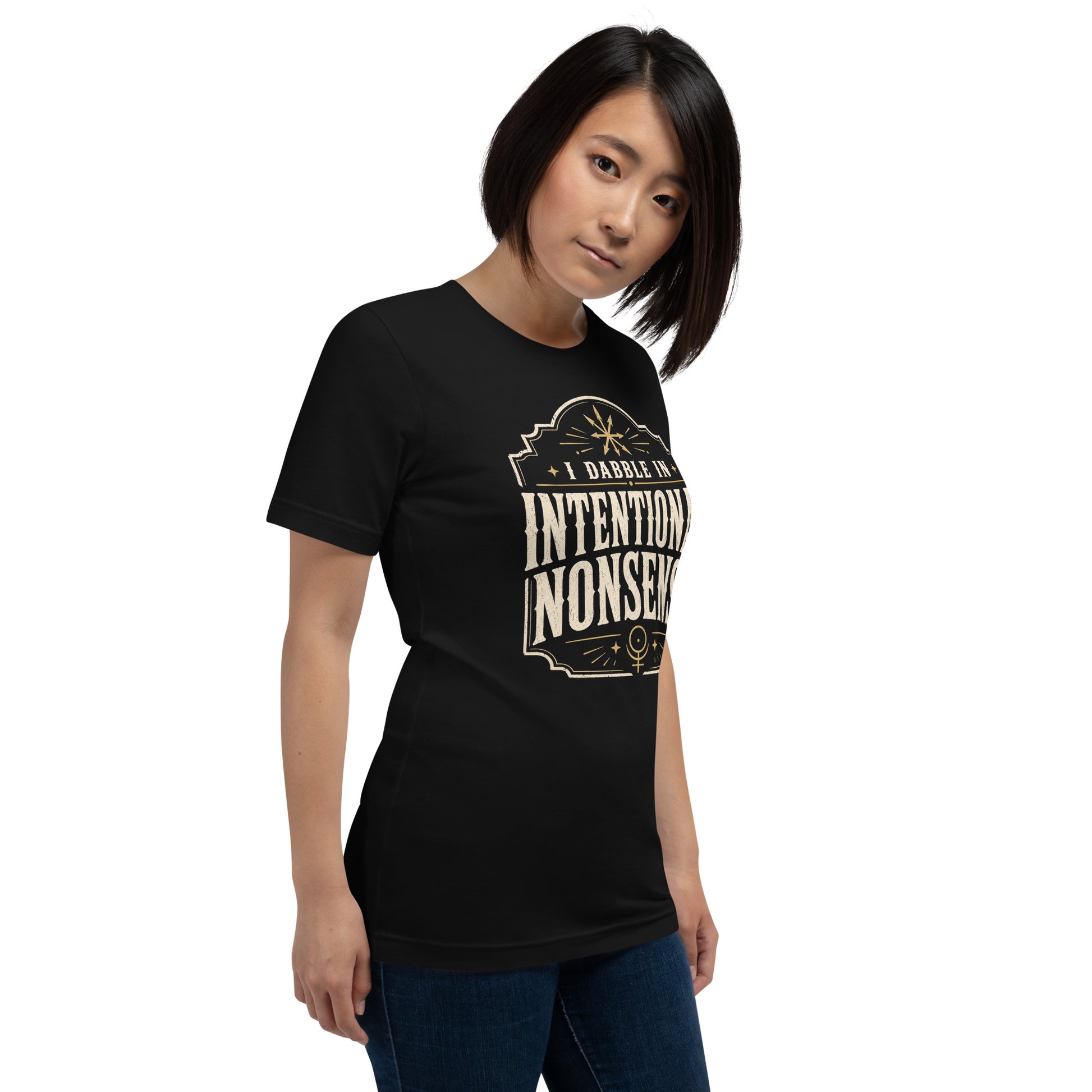 Woman wearing black Intentional Nonsense graphic tee with cream lettering and gold decorative details