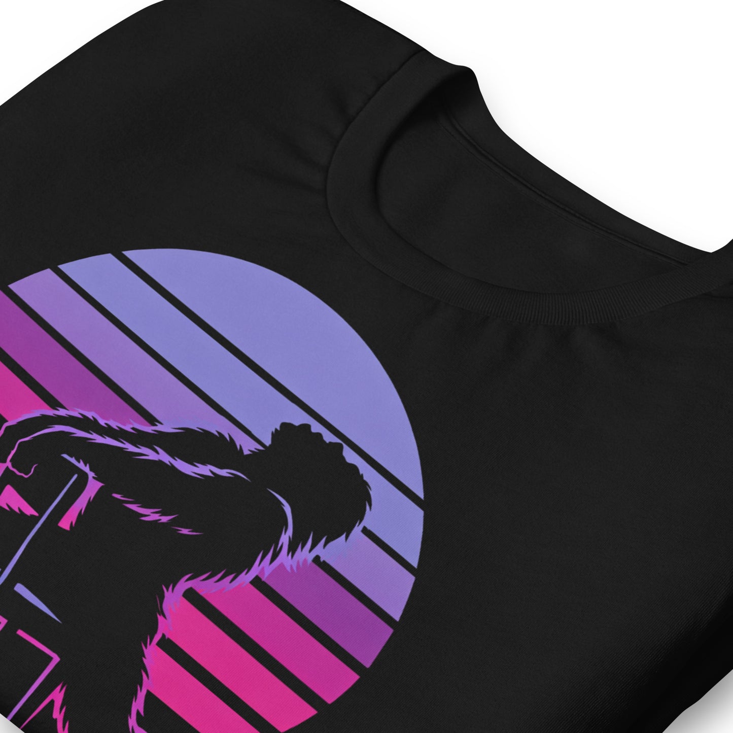 A retro graphic t-shirt featuring the cryptid Bigfoot in the iconic Flashdance chair-pose silhouette against a vibrant 1980s-style sunset.