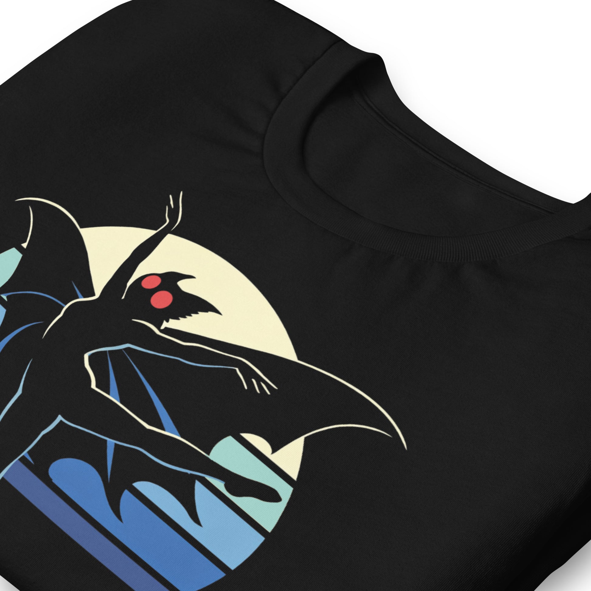 A retro-style graphic t-shirt featuring the winged cryptid Mothman in a ballet dance pose wearing a tutu, set against a vibrant neon 80s sunburst background.