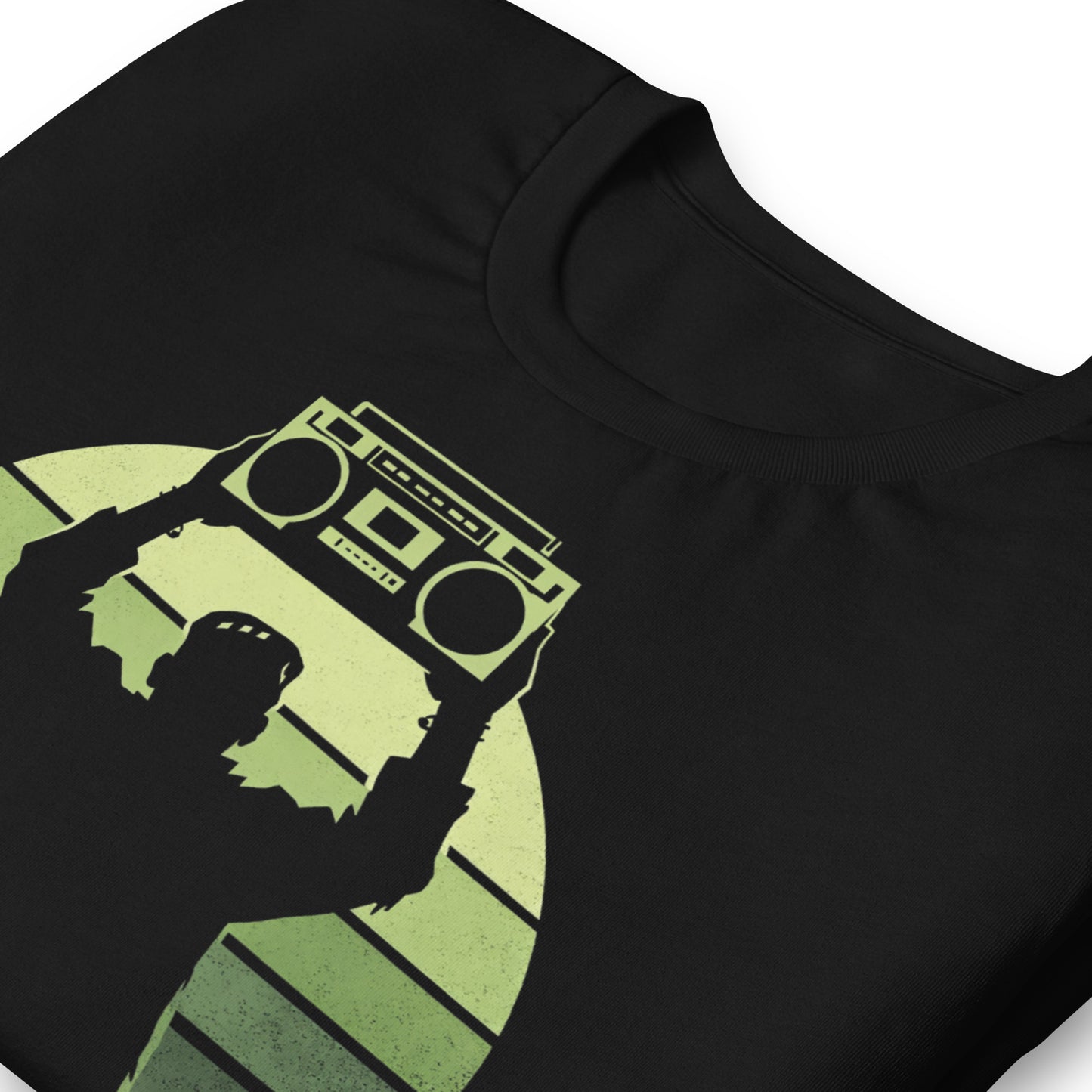 A retro-style graphic t-shirt featuring Frankenstein’s monster holding a 1980s boombox over his head in the iconic Say Anything movie pose, set against a vibrant neon sunburst.