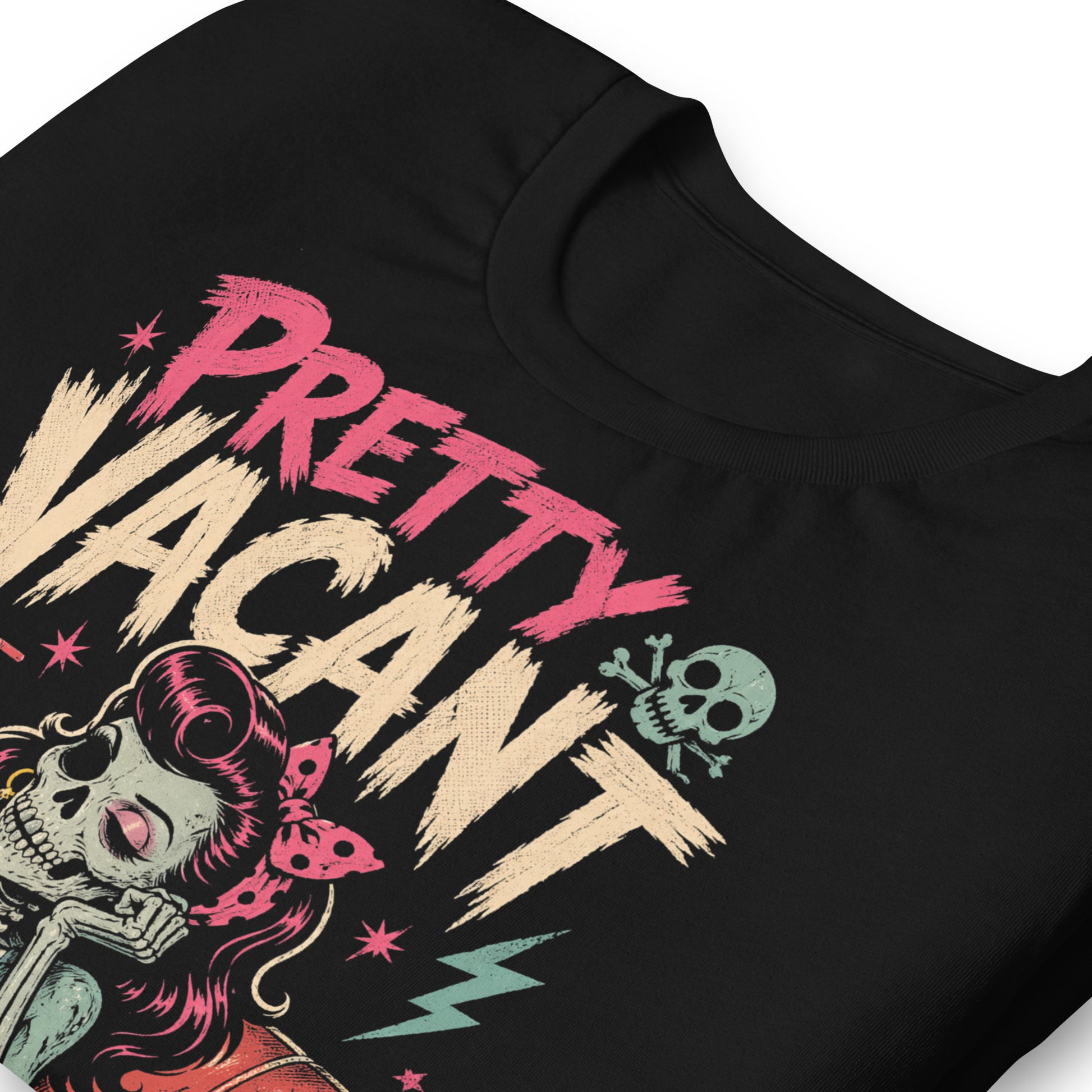 A retro-style graphic on a black t-shirt of a female skeleton pinup with pink hair in a diner booth, holding a skull-themed milkshake next to a burger with a crossbones flag.