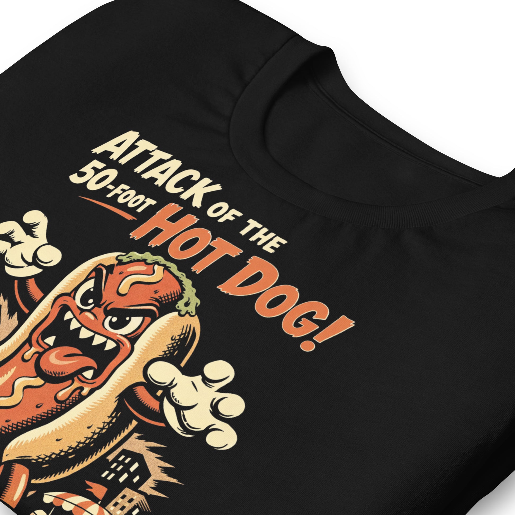 A retro B-movie style graphic t-shirt featuring a giant 50-foot hot dog attacking a vintage city skyline, with campy horror-themed cinematic lettering.