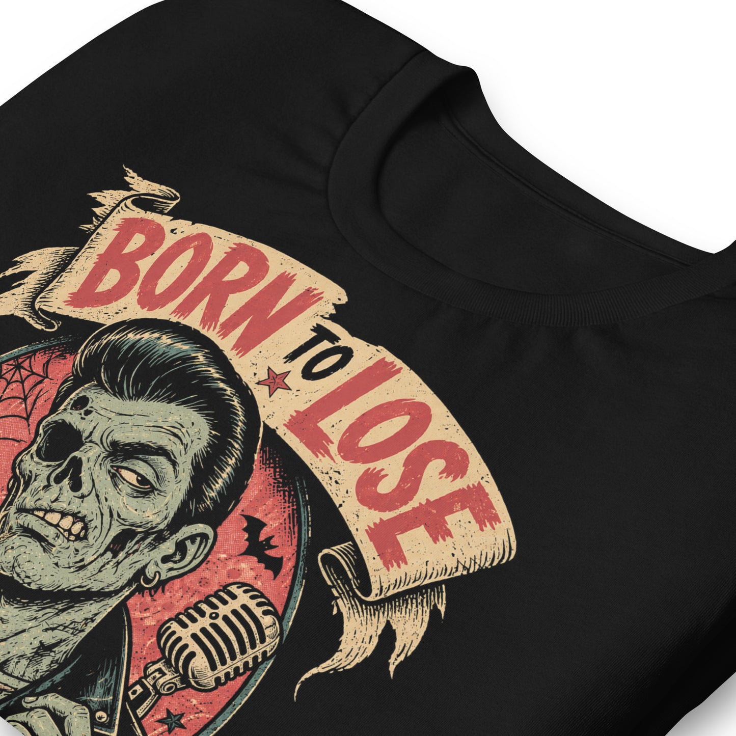 A vintage tattoo flash-style graphic on a black t-shirt featuring a green-skinned zombie monster with a banner that says "Born to Lose"