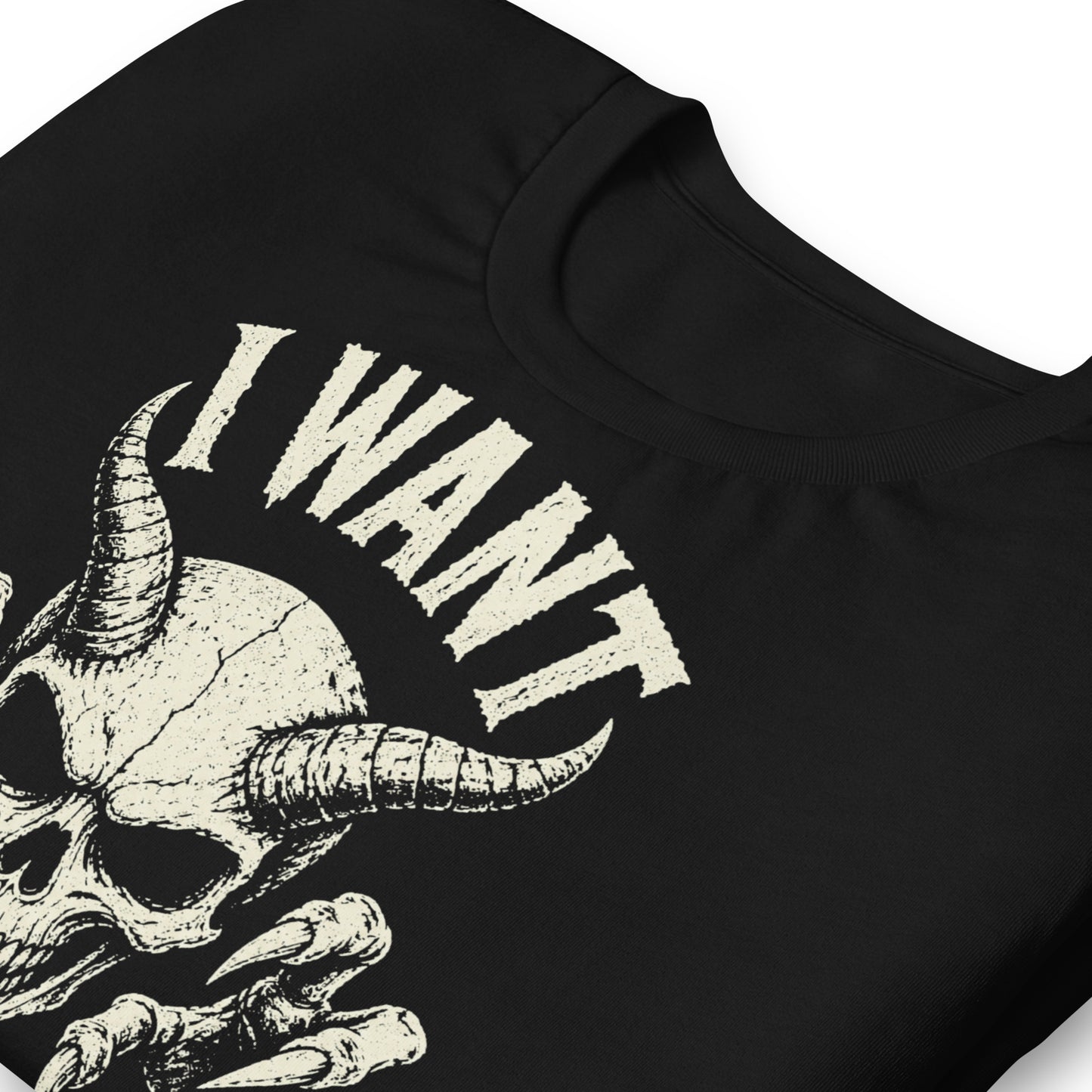 A retro-style graphic on a black t-shirt featuring a detailed horned demon skull with sharp claws and "I WANT YOUR SKULL" in distressed punk-rock lettering.