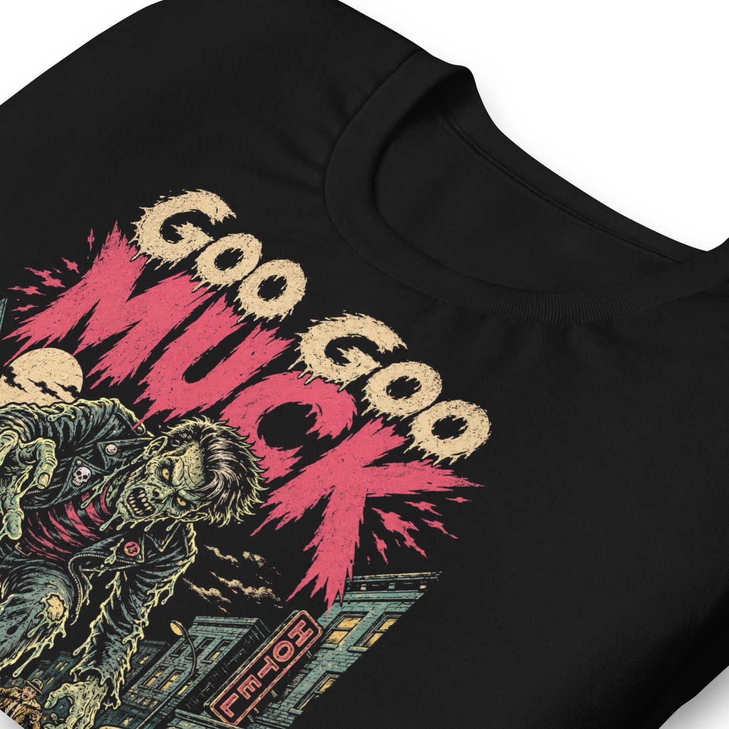 A retro-style graphic on a black t-shirt featuring a teenage monster with a pompadour, wearing a red and black striped shirt and a black leather jacket, with "GOO GOO MUCK" in distressed lettering.