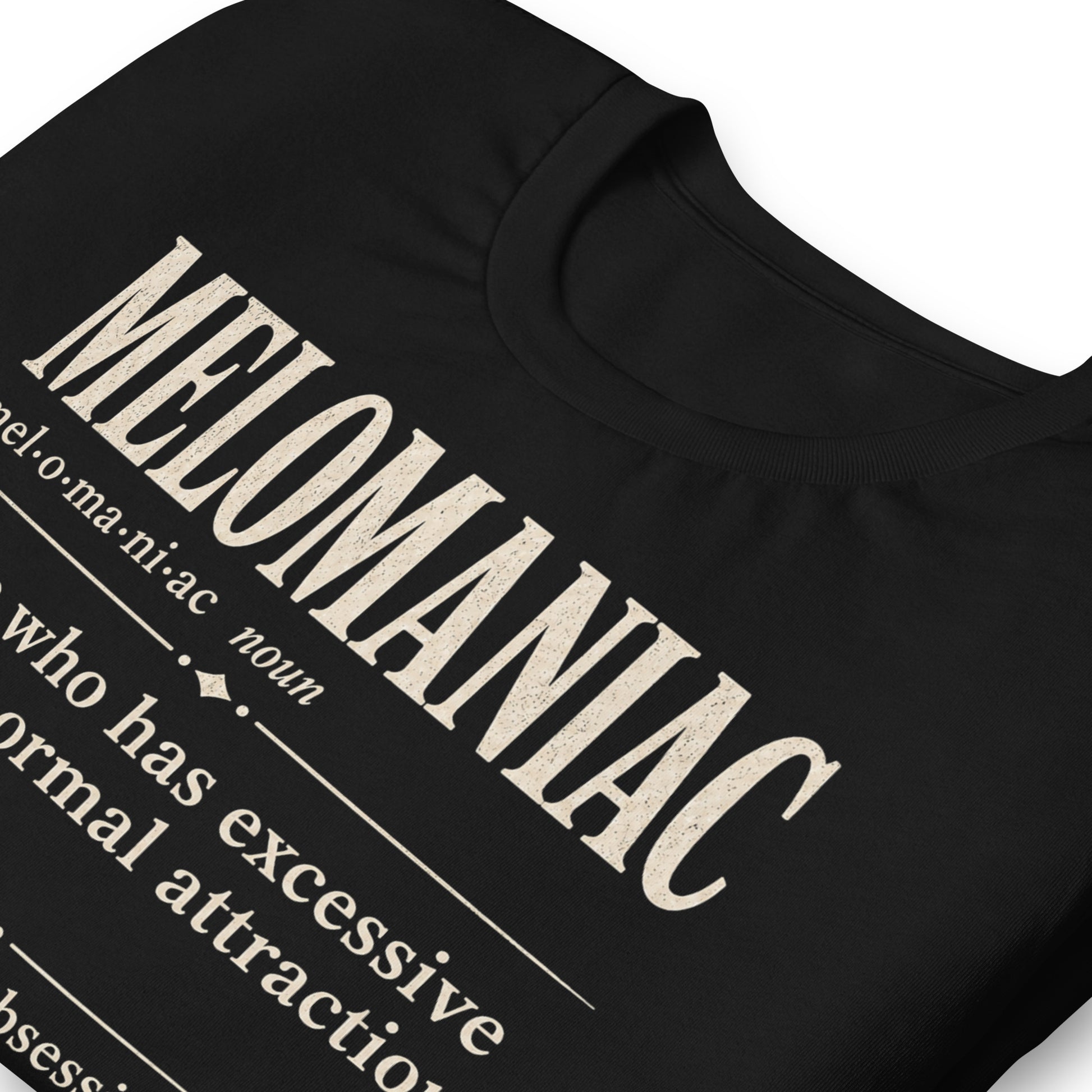 Melomaniac dictionary definition t-shirt on black Bella Canvas tee with cream typography and music lover definition