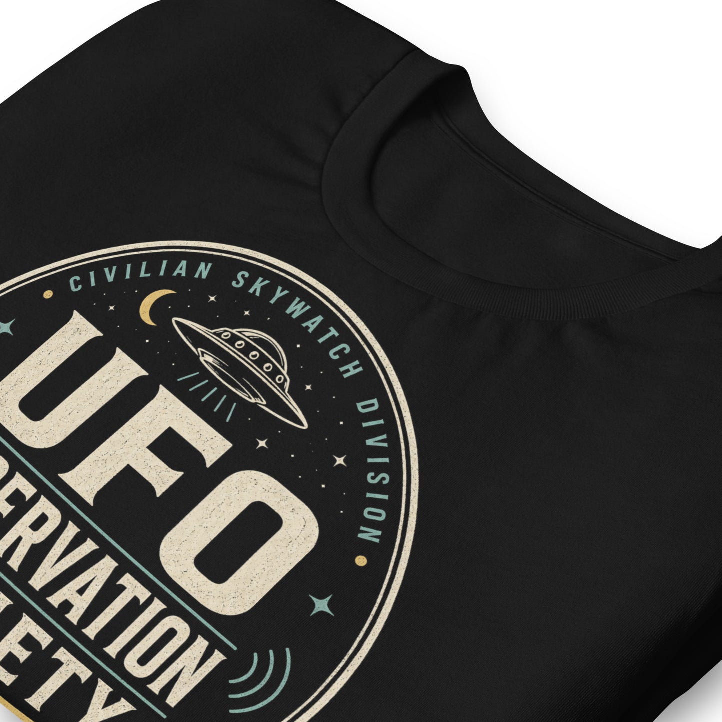 Close-up of UFO Observation Society t-shirt design with flying saucer, night sky details, and retro observation club typography