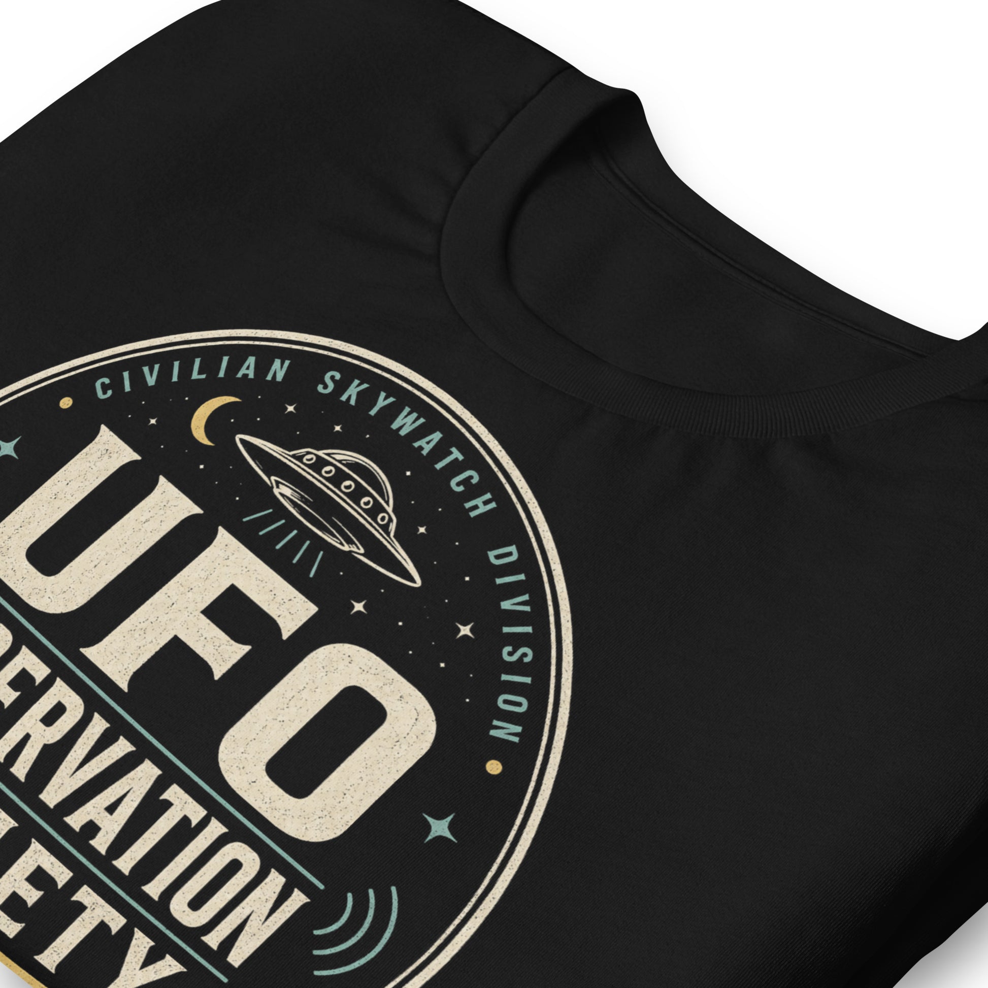 Close-up of UFO Observation Society t-shirt design with flying saucer, night sky details, and retro observation club typography