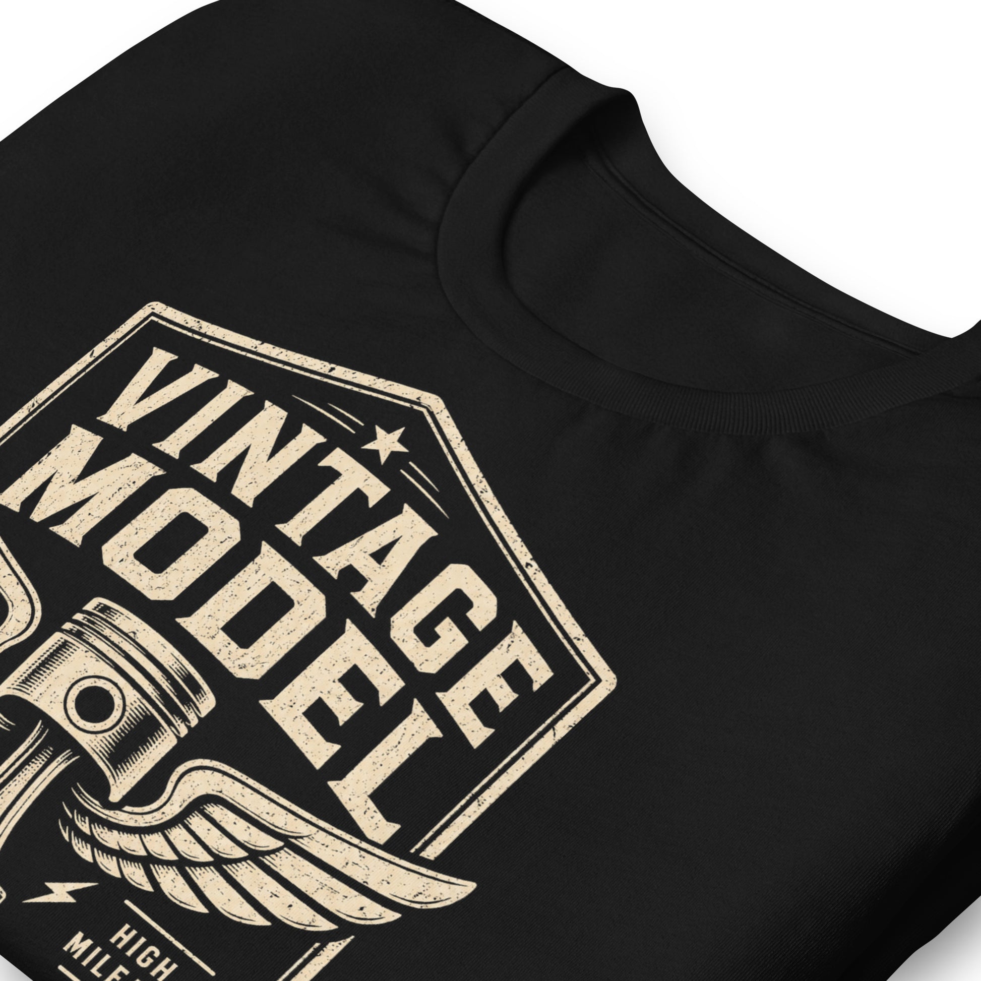A black graphic tee featuring original Cinderpoint Studios artwork for Vintage Model, a one-color retro garage badge design with bold lettering, a winged piston, and text including Road Tested, High Mileage, Original Parts, and Classic Edition.