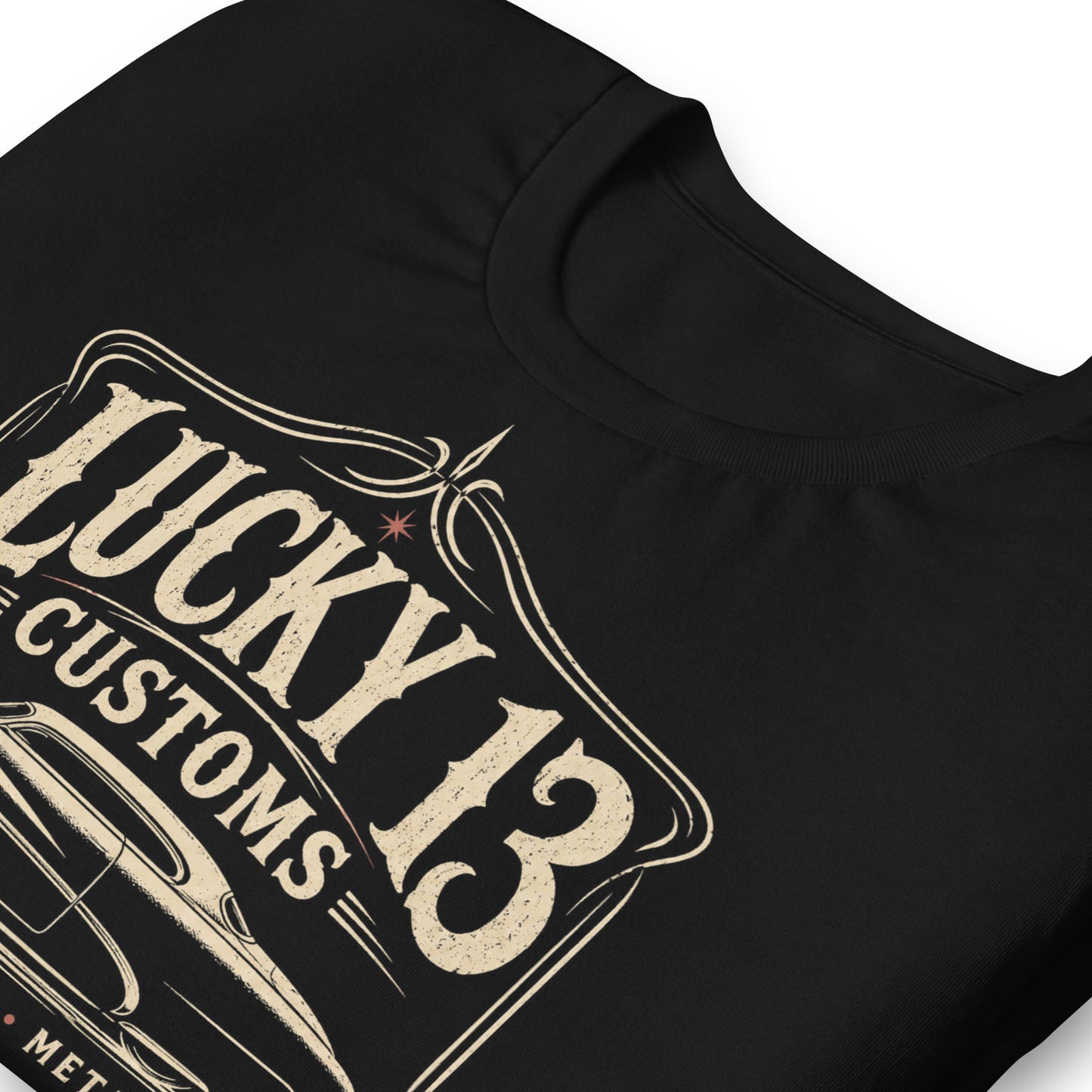 A black graphic tee featuring original Cinderpoint Studios artwork for Lucky 13 Customs, a retro custom shop design with a lowrider-style classic car, bold vintage lettering, winged 13 emblem, pinstripe-style frame, and Low & Slow Specialists text.