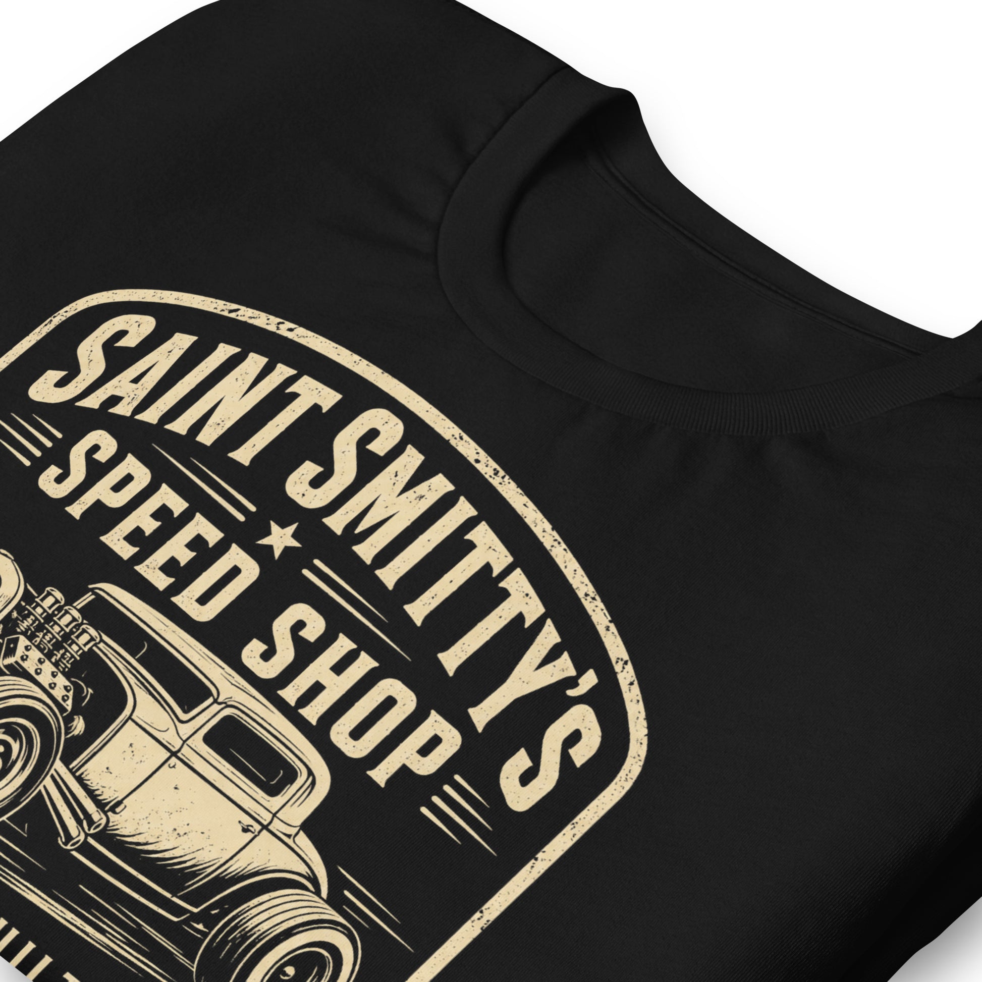 A black graphic tee featuring original Cinderpoint Studios artwork for Saint Smitty’s Speed Shop, a one-color retro hot rod garage design with vintage lettering, classic coupe artwork, spark plugs, and Custom Built Unholy Speed text.