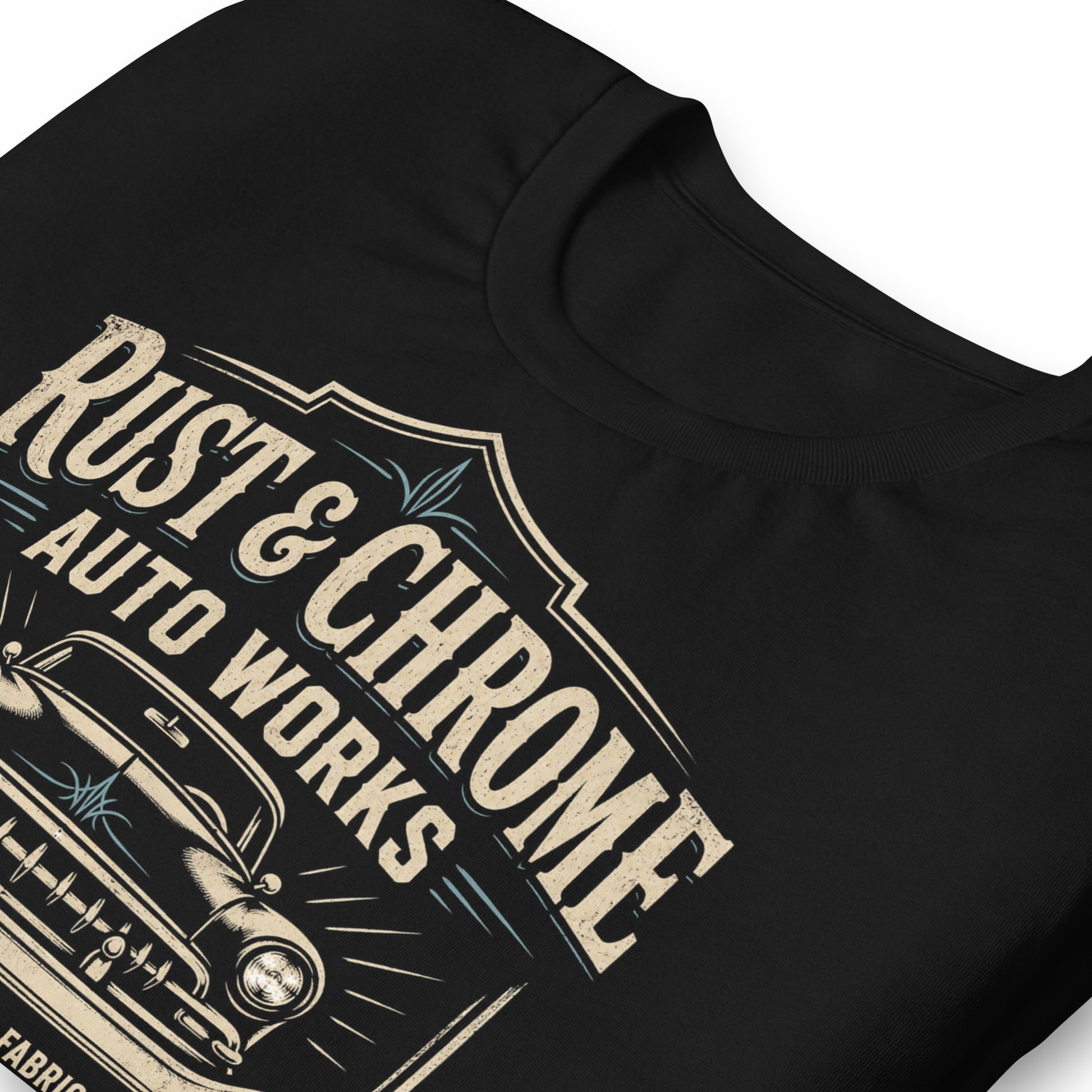 A black graphic tee featuring original Cinderpoint Studios artwork for Rust & Chrome Auto Works, a vintage garage design with a front-facing classic car, bold lettering, wrench accent, spark plug detail, restoration and custom fabrication text, and shield-style framing.