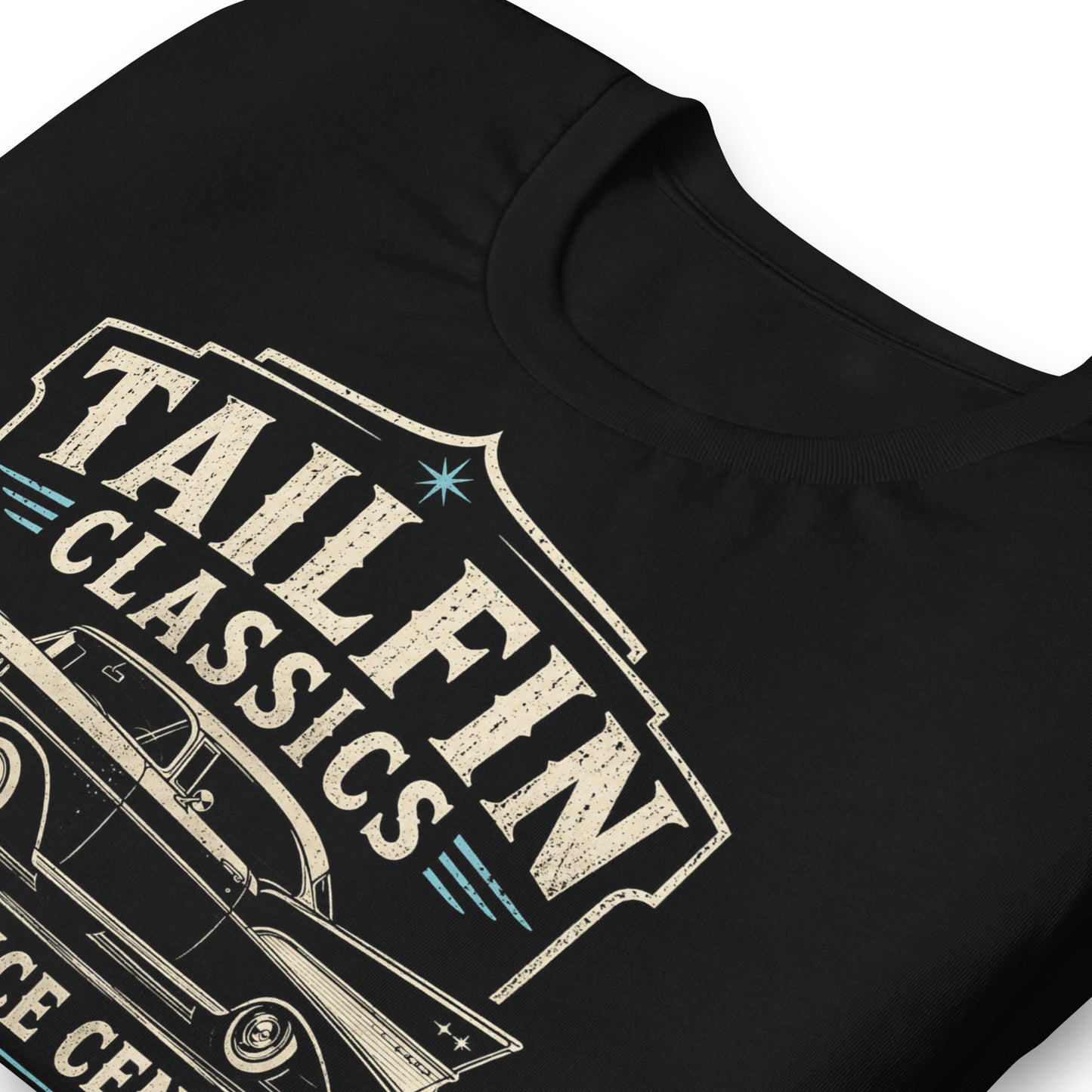Black graphic tee featuring original Cinderpoint Studios artwork for Tailfin Classics, a retro auto service center design with a 1950s-style classic car, bold tailfins, vintage lettering, teal accents, crossed wrenches, spark plugs, and Alignment Brakes Suspension text.